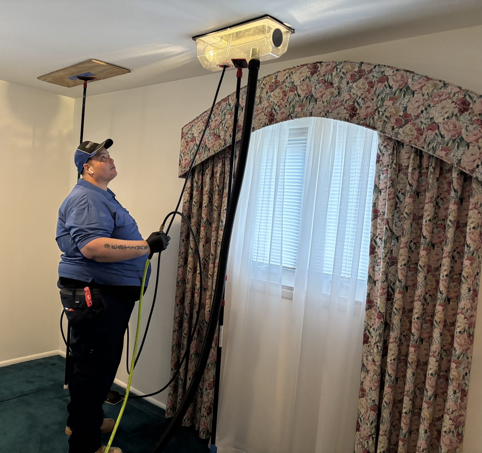 A PCRS technician cleaning a residential air duct