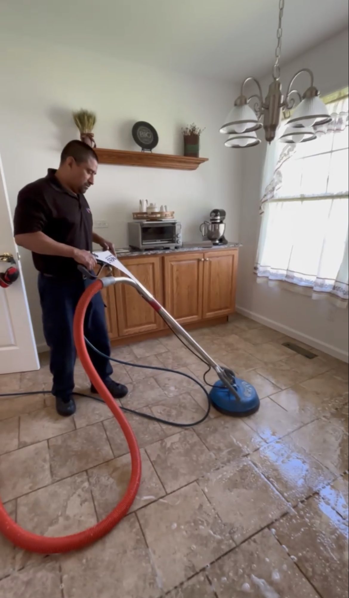 A PCRS technician deep-cleaning a tile floor